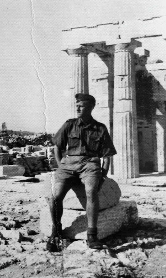 The Cursed Generation. Talking to Wehrmacht Soldiers for the Last Time 3 Black-and-white historical photograph of Karl Friedrich, a Wehrmacht soldier seated among ancient ruins, connected to The Cursed Generation oral-history testimony